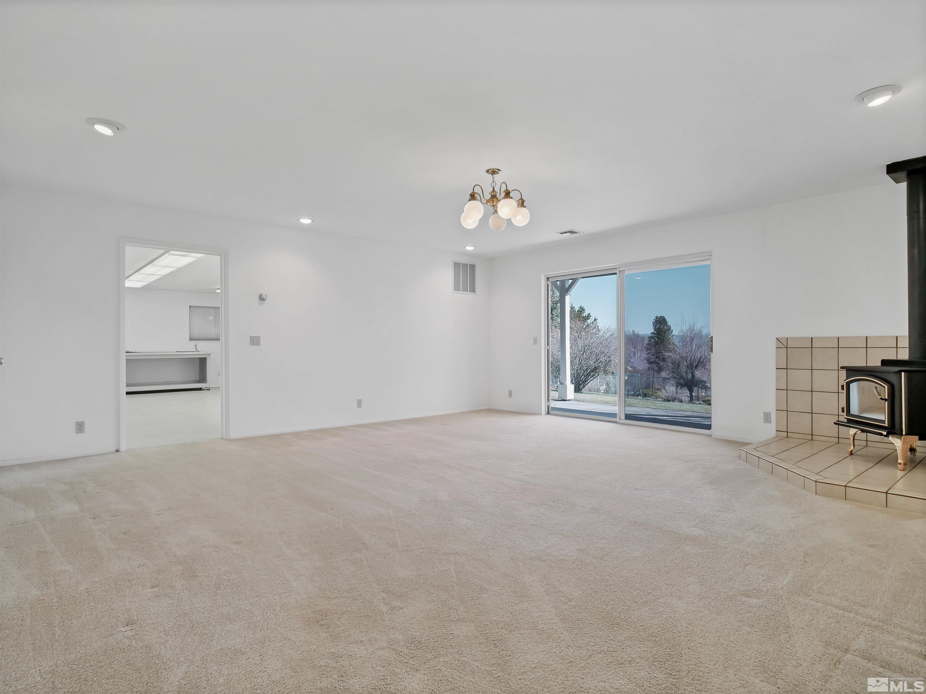 875 Bollen Circle Gardnerville, NV 89460 - Photo 21 of 26 a living room with furniture and a chandelier