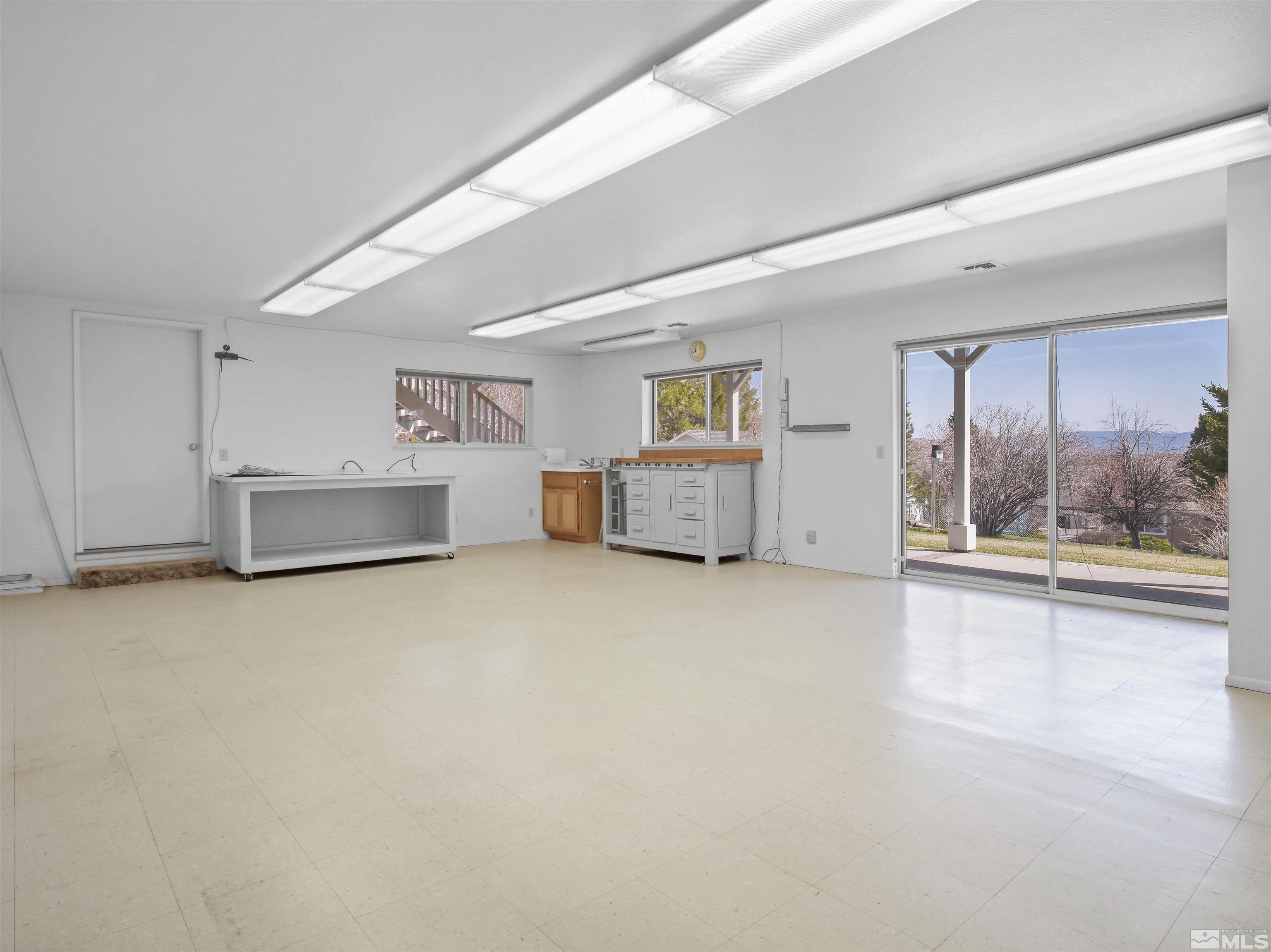 875 Bollen Circle Gardnerville, NV 89460 - Photo 22 of 26 an empty room with a fireplace and window