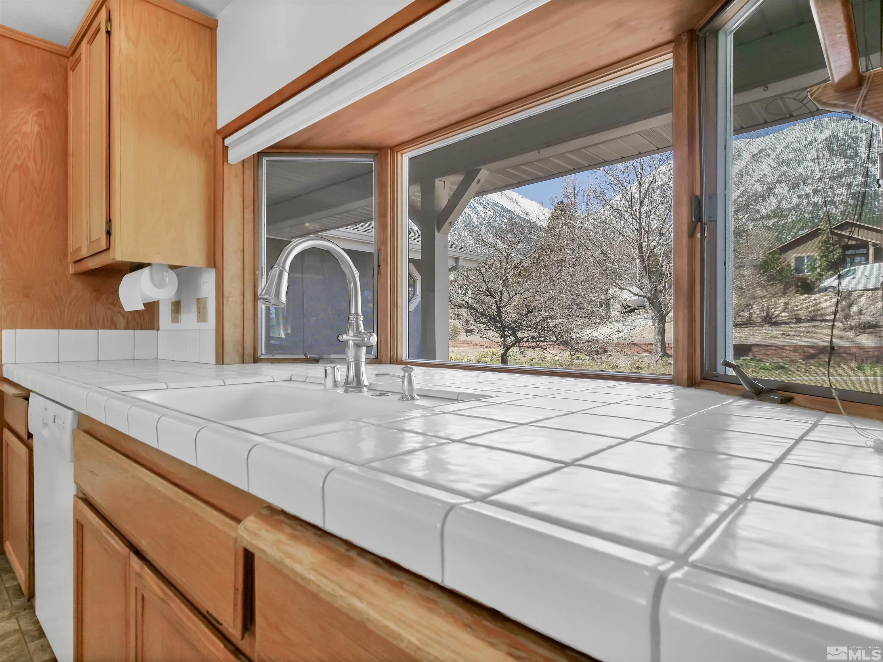 875 Bollen Circle Gardnerville, NV 89460 - Photo 5 of 26 a view of a sink and a large mirror next to a window