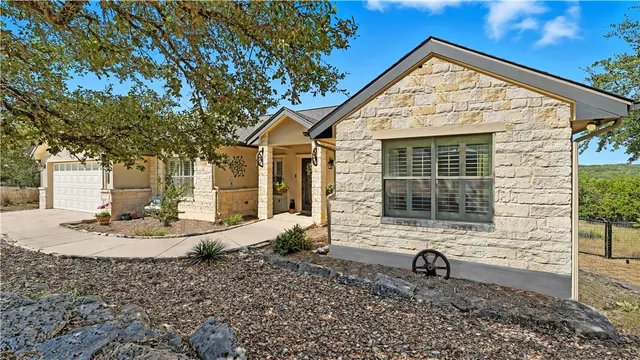 a view of a house with a backyard and sitting area
