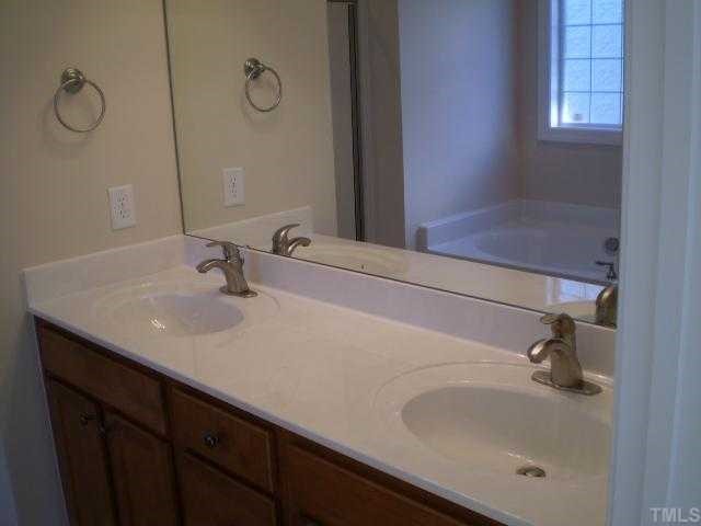 5720 Spring Glen Lane Raleigh, NC 27616 - Photo 11 of 12 Master bathroom with double vanity and toilet closet