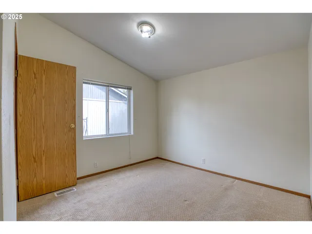 a view of an empty room and a window