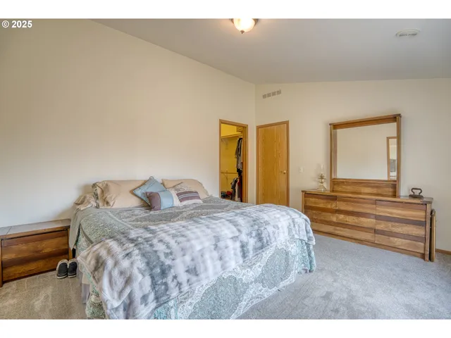 a bedroom with a bed and a dresser