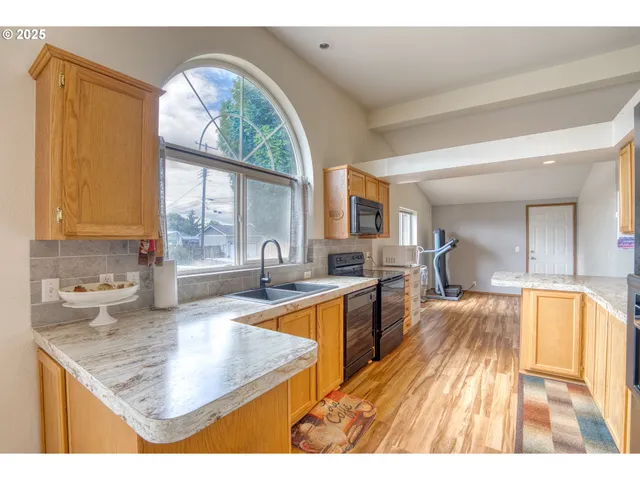 a kitchen with stainless steel appliances granite countertop a stove and a sink