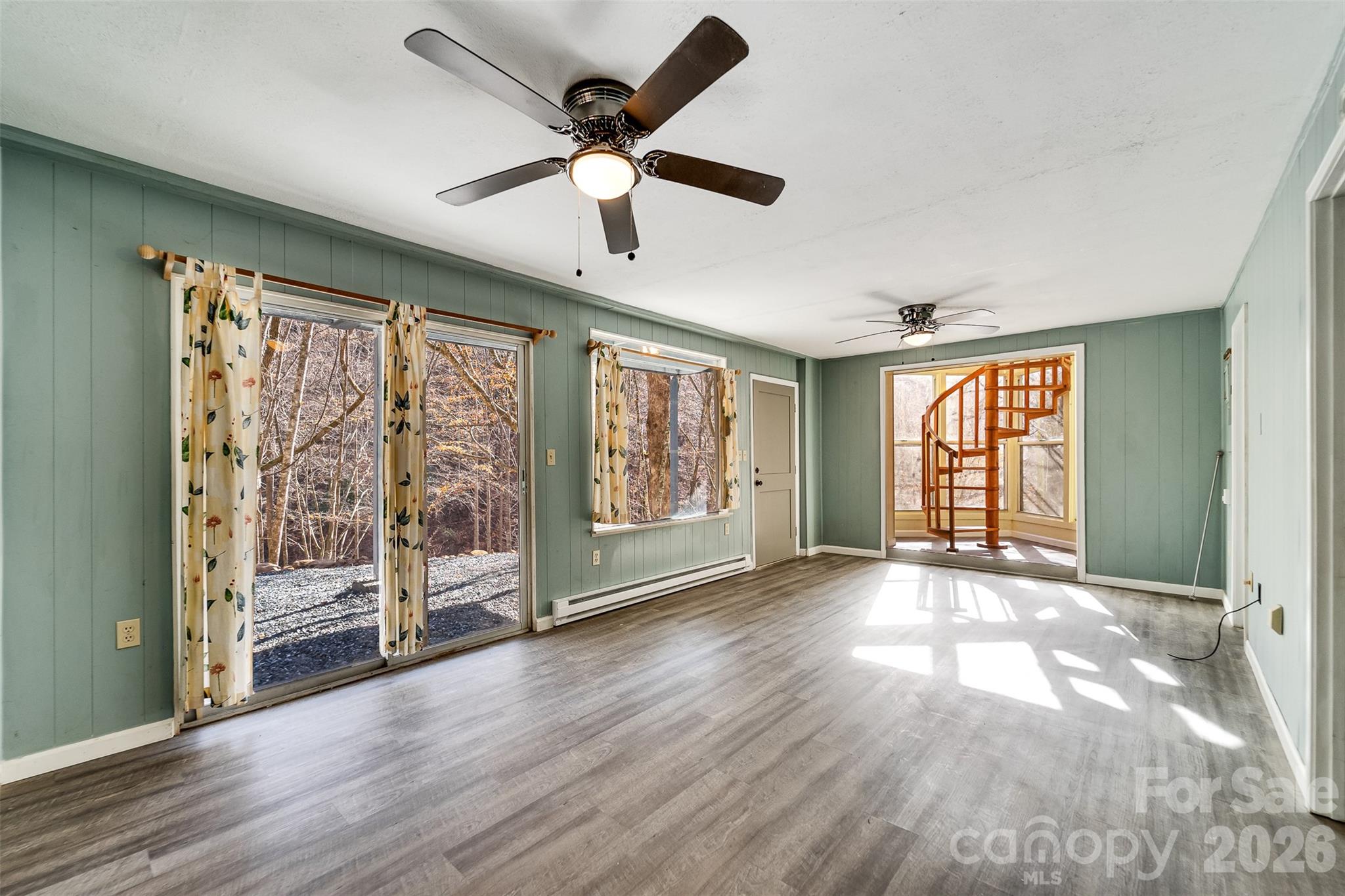 744 Coon Creek Road Franklin, NC 28734 - Photo 11 of 21 a view of an empty room with a window and wooden floor
