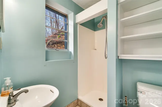 a bathroom with a toilet and a shower