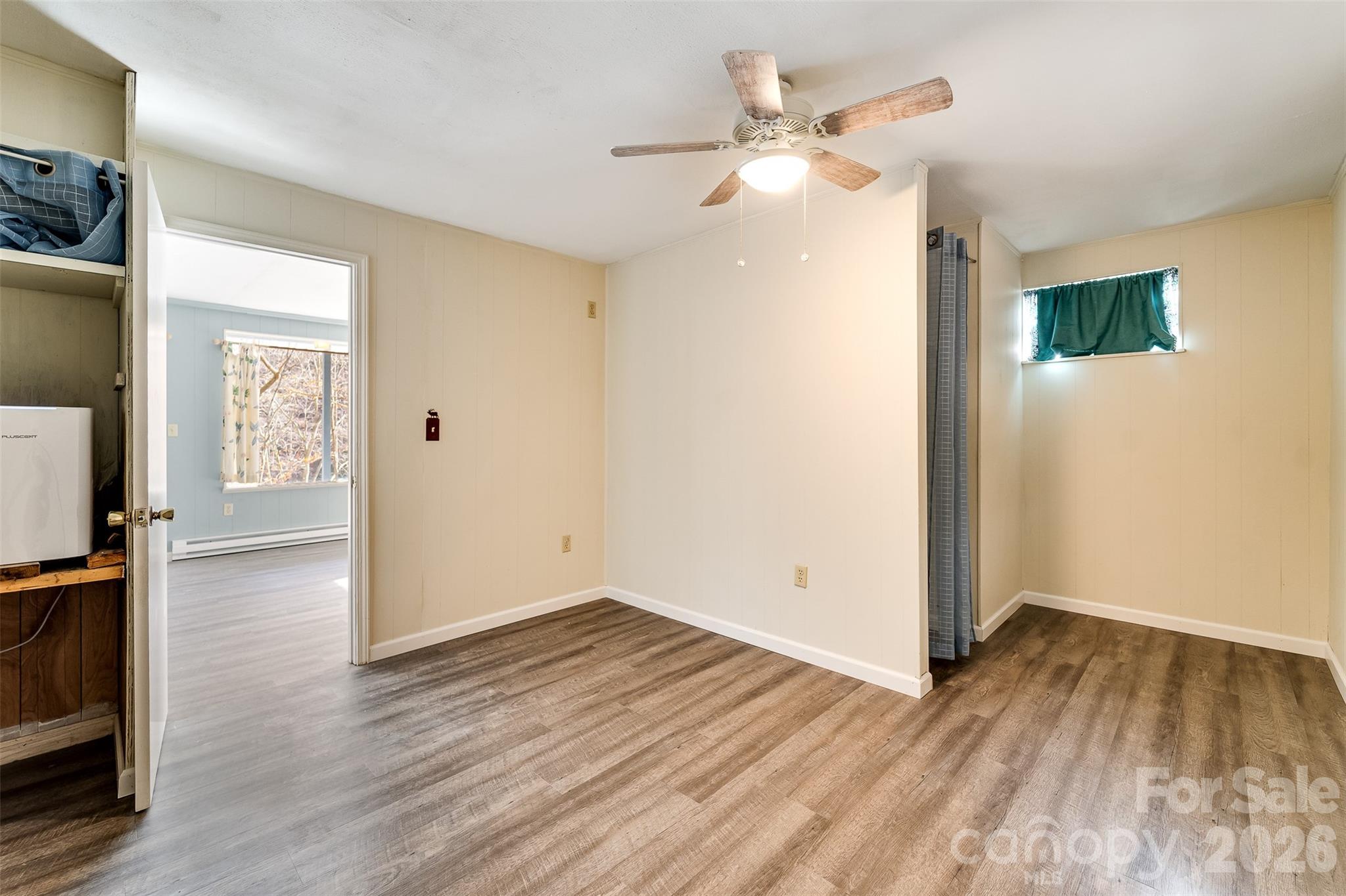 744 Coon Creek Road Franklin, NC 28734 - Photo 14 of 21 wooden floor in an empty room with a window