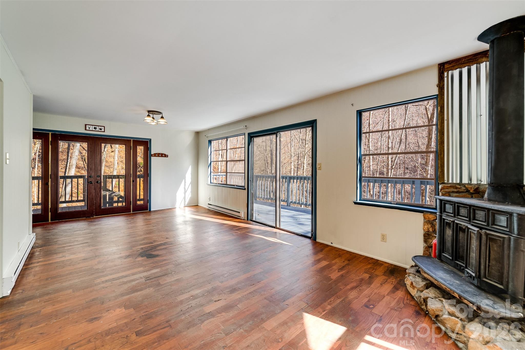 744 Coon Creek Road Franklin, NC 28734 - Photo 5 of 21 wooden floor in an empty room with a window