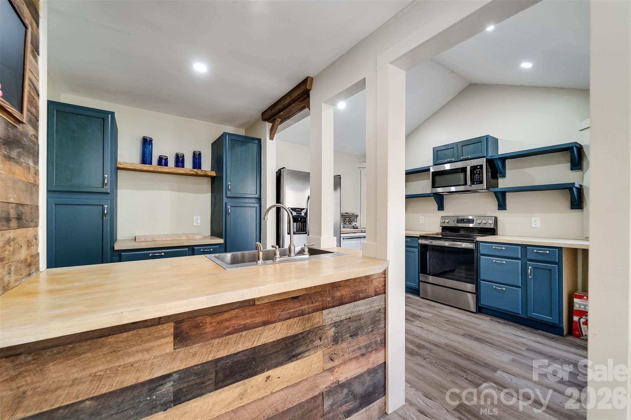 744 Coon Creek Road Franklin, NC 28734 - Photo 6 of 21 a kitchen with stainless steel appliances granite countertop a stove and a refrigerator