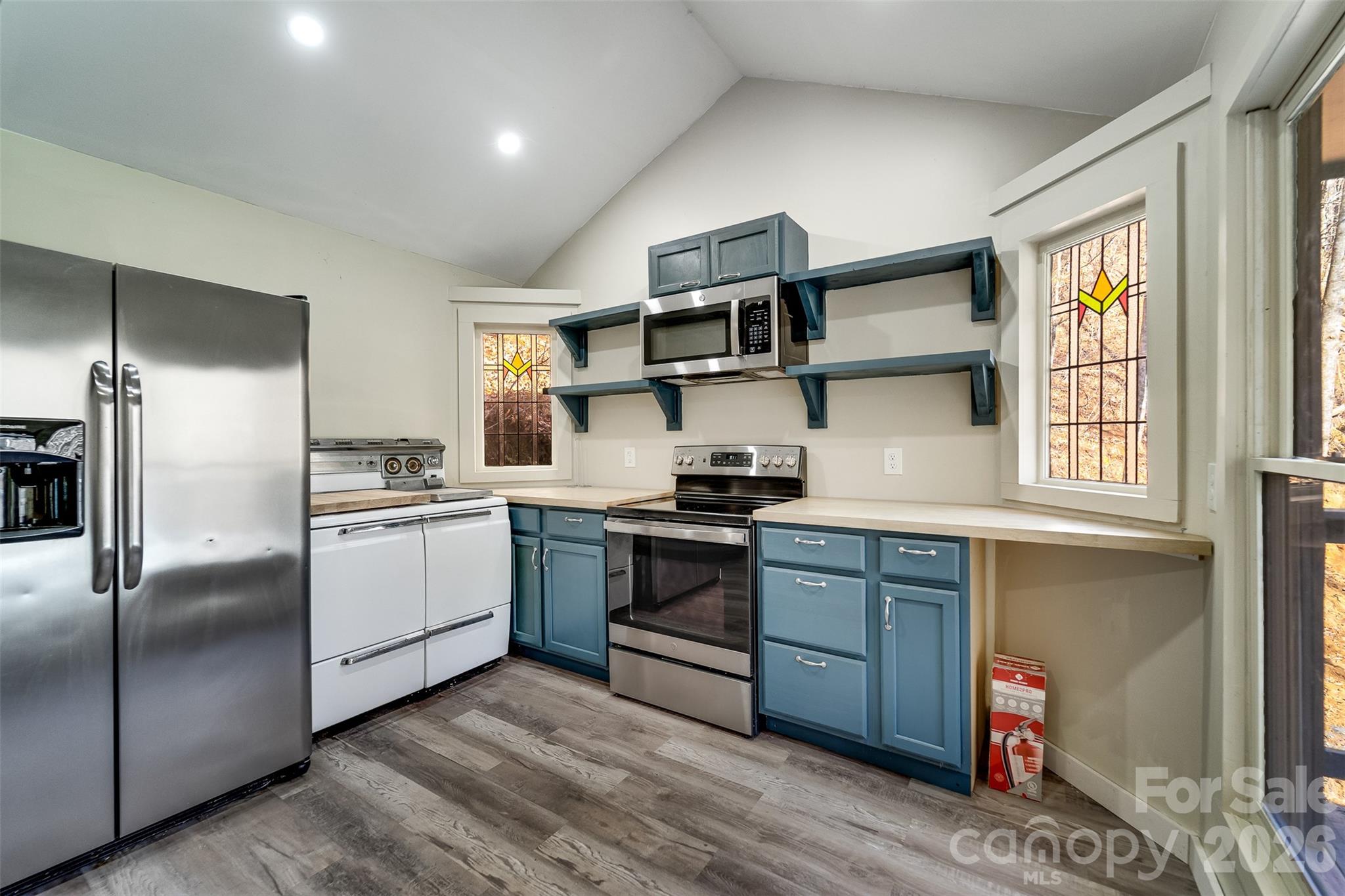 744 Coon Creek Road Franklin, NC 28734 - Photo 7 of 21 a kitchen with stainless steel appliances granite countertop a sink and wooden floors