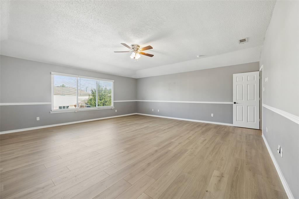 753 Summerfield Drive Allen, TX 75002 - Photo 31 of 40 Spacious interior featuring light wood-finish flooring, a contemporary ceiling fan, and a large window providing ample natural illumination