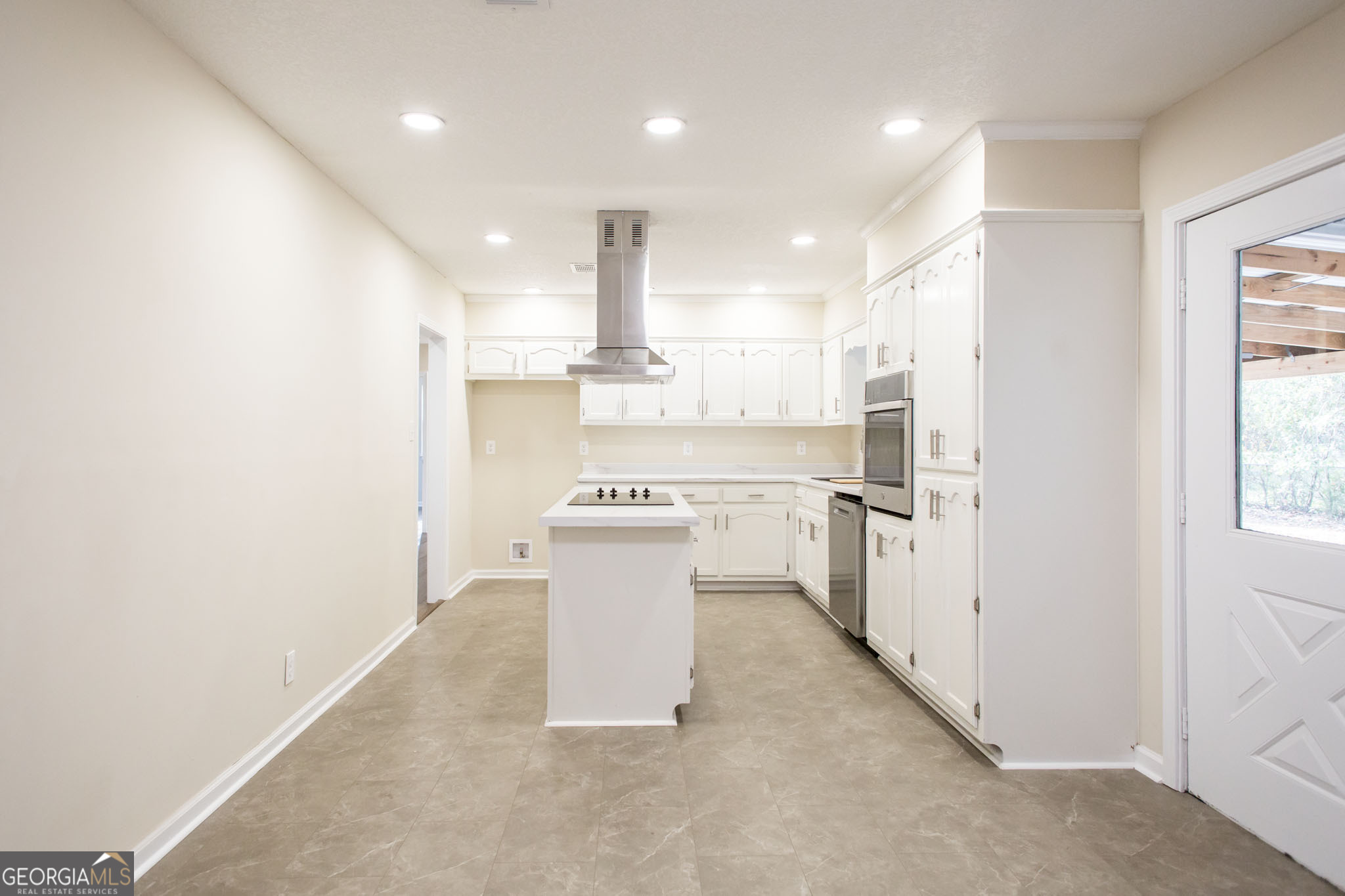 407 Pineview Drive Waycross, GA 31501 - Photo 13 of 35 a view of a kitchen with a sink and dishwasher a refrigerator with white cabinets
