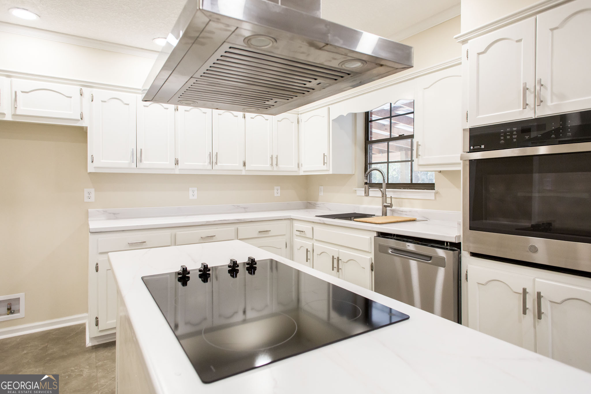 407 Pineview Drive Waycross, GA 31501 - Photo 14 of 35 a kitchen with stainless steel appliances kitchen island granite countertop a sink a stove and cabinets