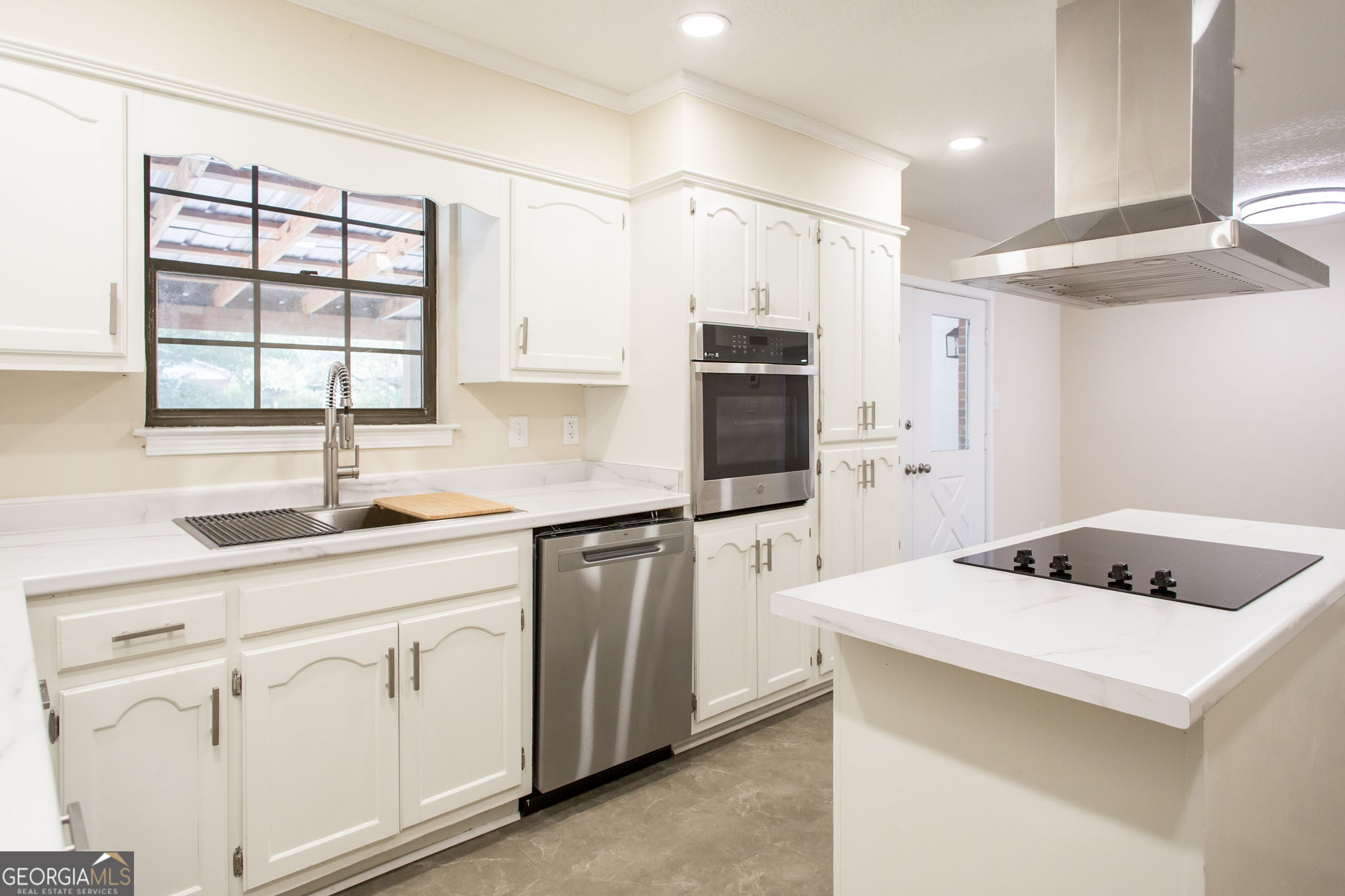407 Pineview Drive Waycross, GA 31501 - Photo 15 of 35 a kitchen with white cabinets and white appliances
