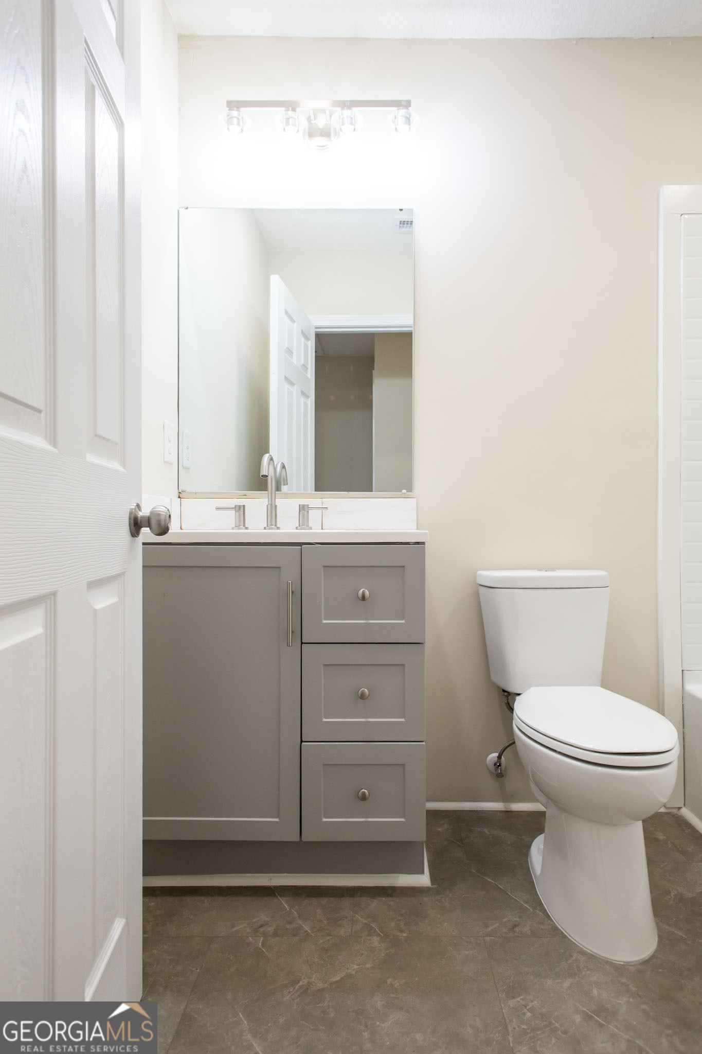 407 Pineview Drive Waycross, GA 31501 - Photo 18 of 35 a bathroom with a toilet sink and mirror