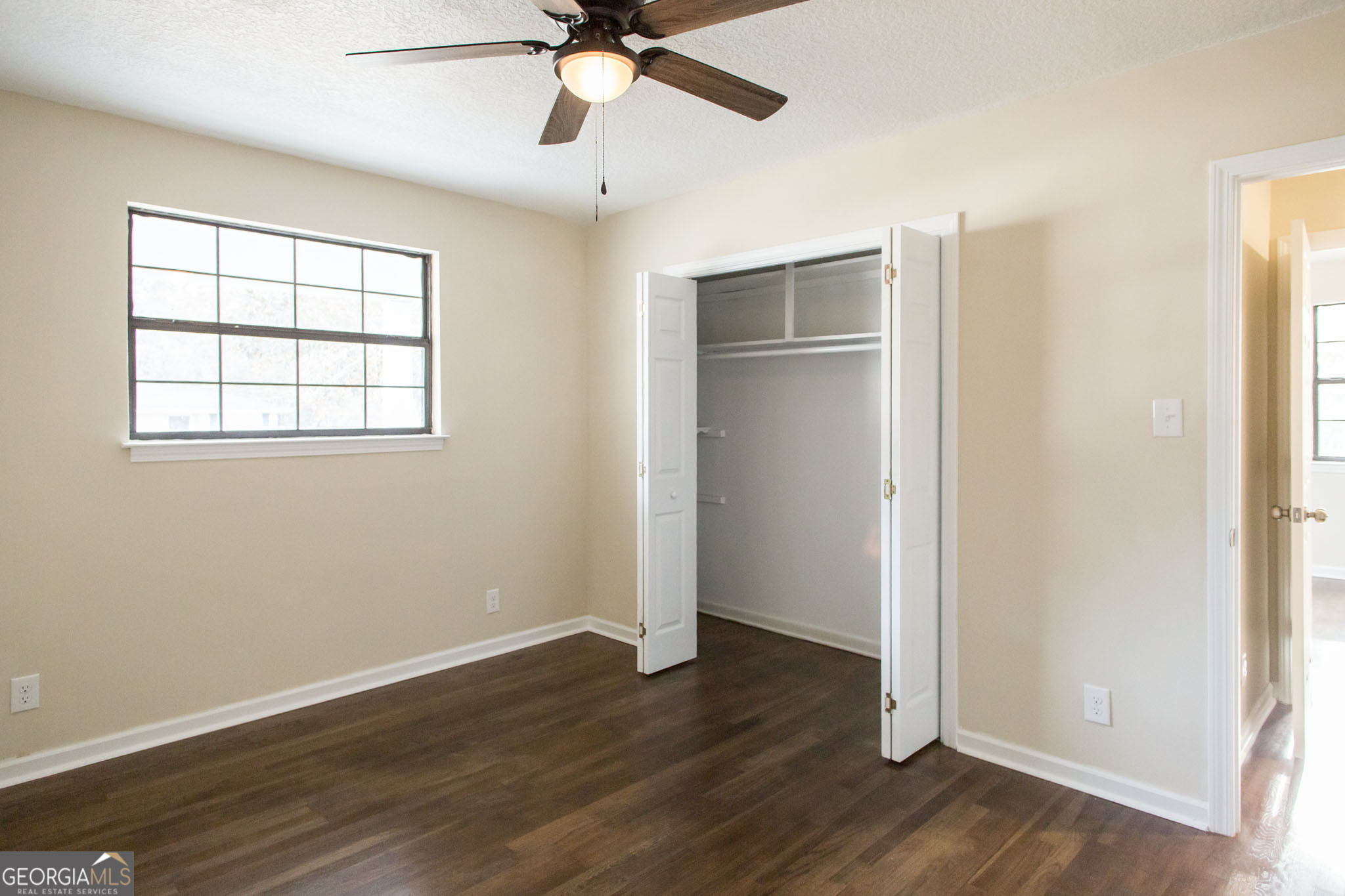 407 Pineview Drive Waycross, GA 31501 - Photo 20 of 35 an empty room with wooden floor closet and windows