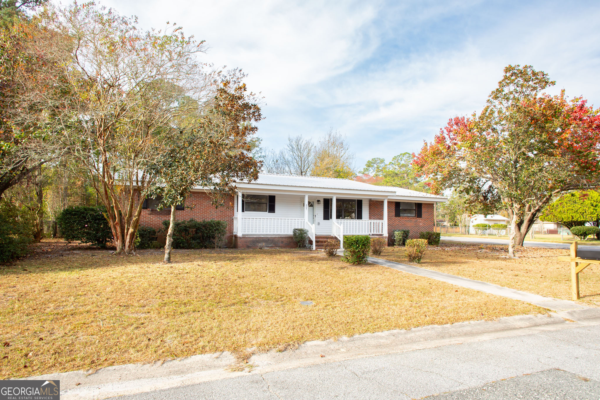 407 Pineview Drive Waycross, GA 31501 - Photo 3 of 35 a front view of a house with a yard and trees