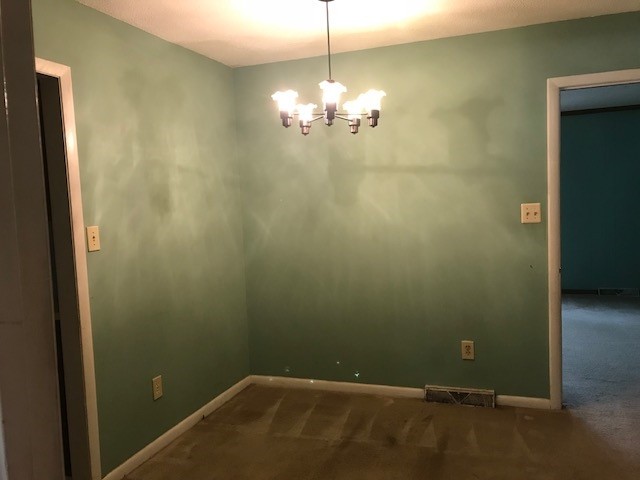 7209 Harps Mill Road Raleigh, NC 27615 - Photo 4 of 13 a bathroom with a chandelier