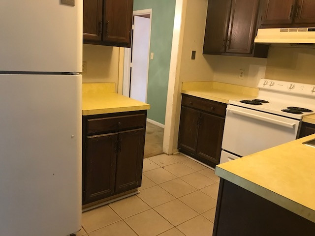7209 Harps Mill Road Raleigh, NC 27615 - Photo 5 of 13 a kitchen with a refrigerator and a stove