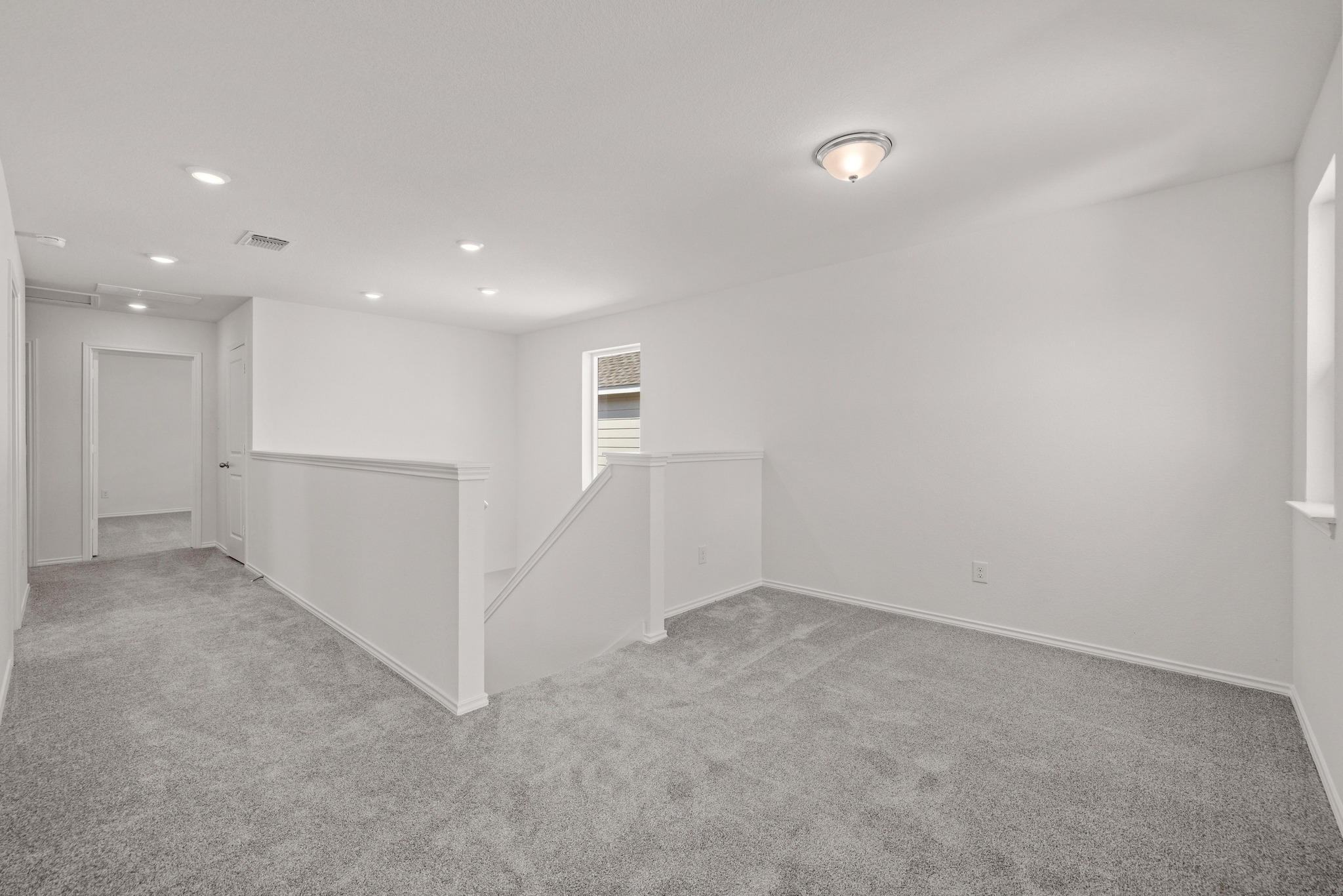 260 Feathers Street Jarrell, TX 76537 - Photo 20 of 34 an empty room with windows and pillars in it