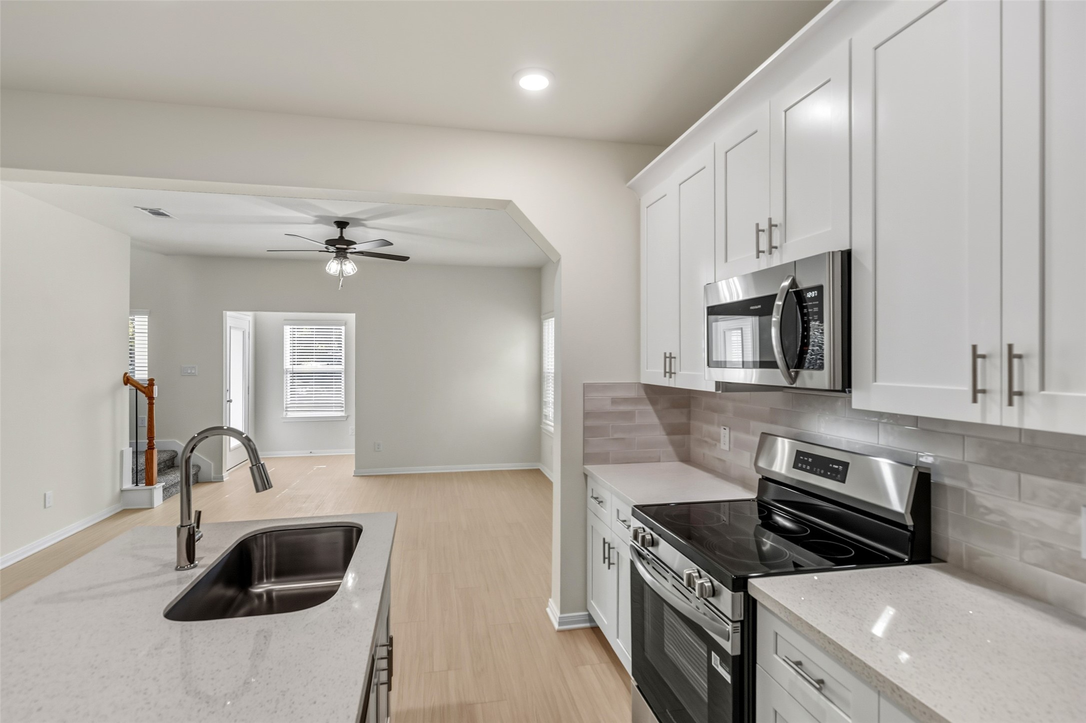 712 West Dallas Street Conroe, TX 77301 - Photo 12 of 23 a kitchen with granite countertop a sink stainless steel appliances and cabinets
