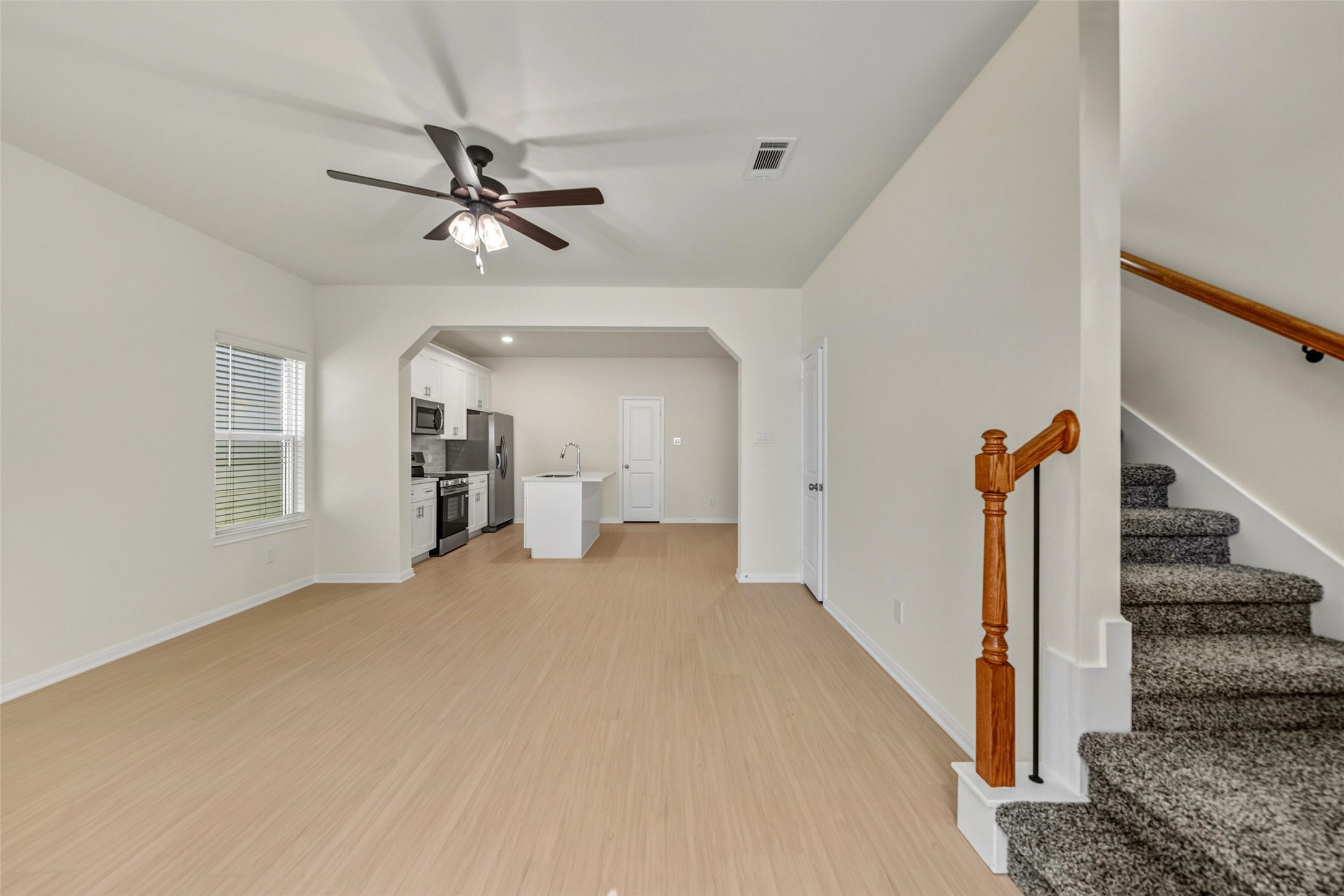 712 West Dallas Street Conroe, TX 77301 - Photo 2 of 23 a view of a livingroom with wooden floor and ceiling fan