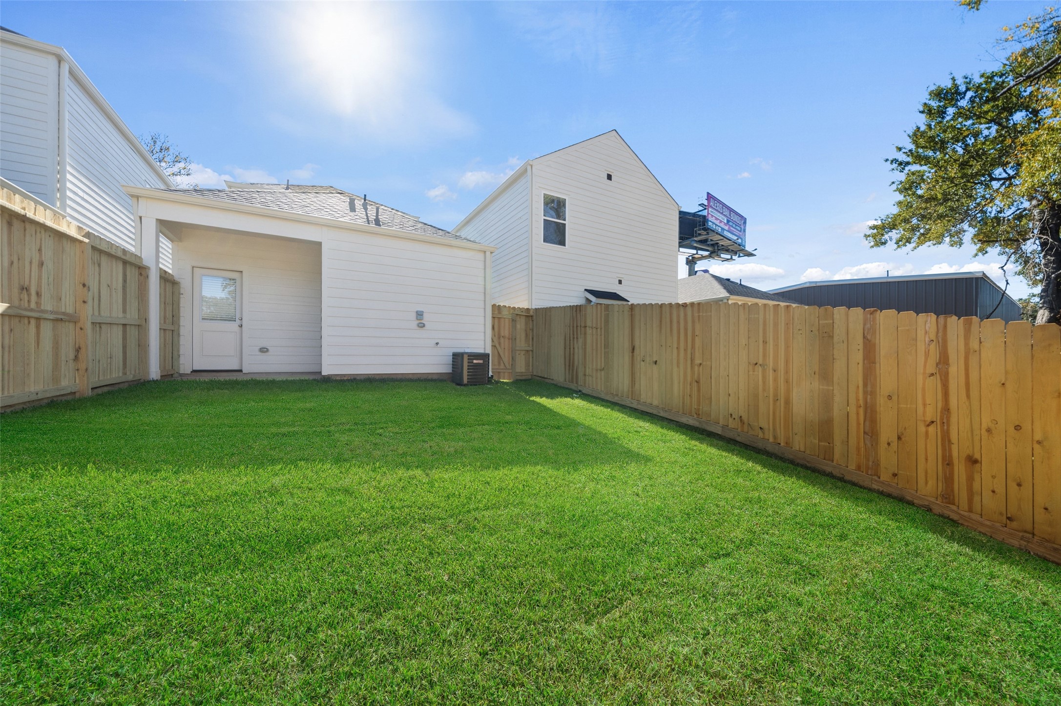 712 West Dallas Street Conroe, TX 77301 - Photo 21 of 23 a view of a backyard with potted plants and wooden fence