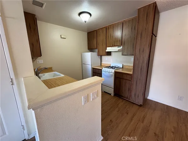 a view of kitchen with cabinets and wooden floor