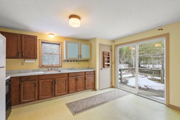 a kitchen with refrigerator and cabinets