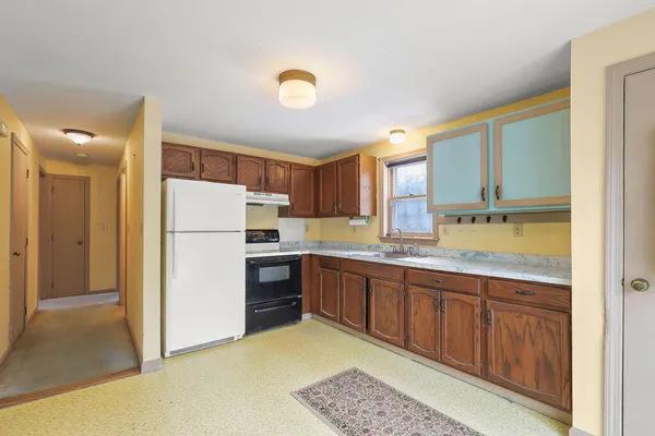 a kitchen with stainless steel appliances a refrigerator and a stove top oven