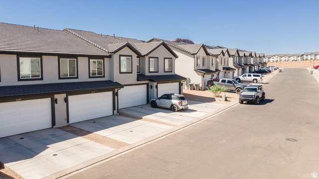 1693 Devils Gdn Lane Washington, UT 84780 - Photo 60 of 64 Contemporary townhome exteriors featuring light gray stucco, dark trim, and dark tile roofing