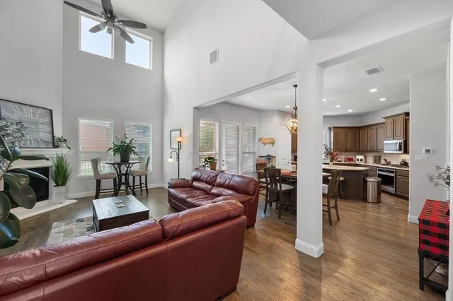 a living room with furniture kitchen view and a refrigerator