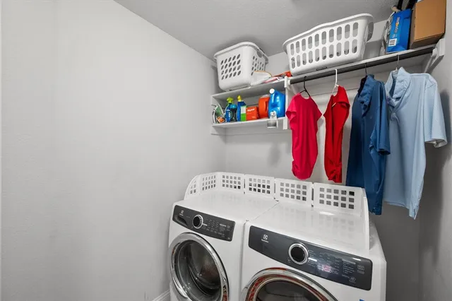 a bedroom with a bed and a dresser with the mirror