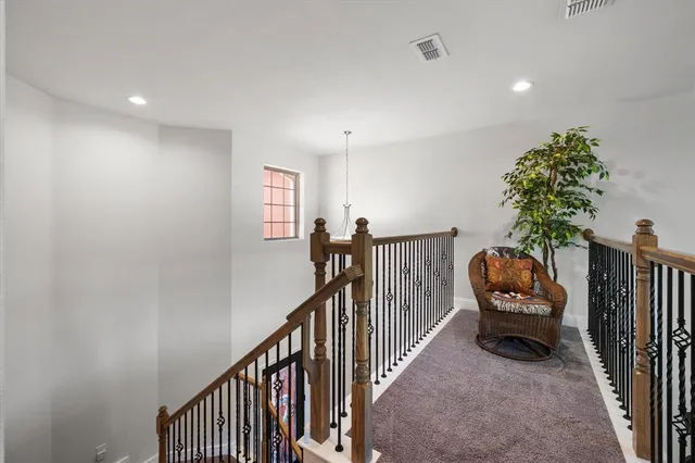 a view of a hallway with entryway and stairs
