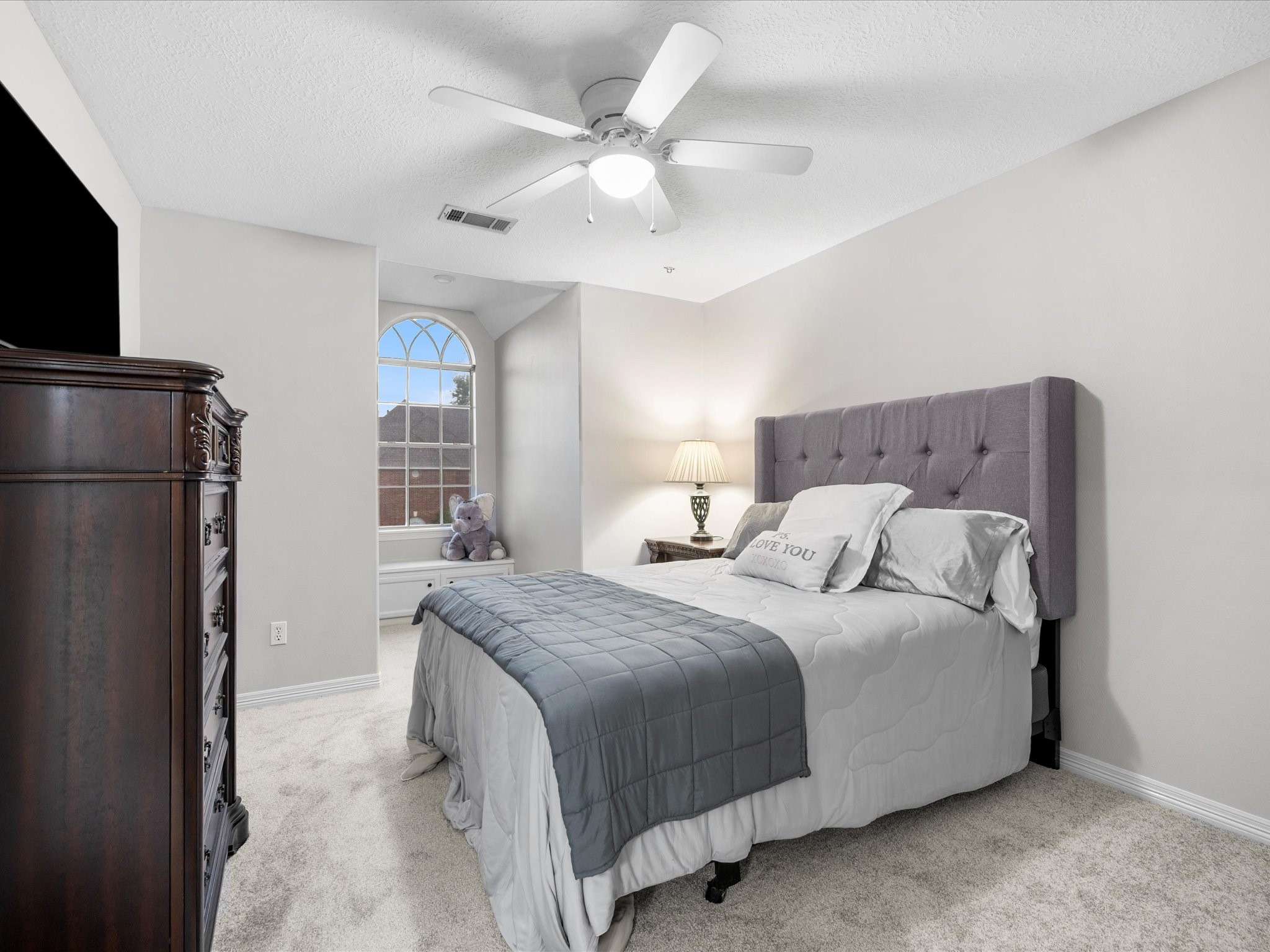 5910 Center Ct Drive Spring, TX 77379 - Photo 31 of 50 A spacious secondary bedroom continues the home’s cohesive design, featuring a charming window nook with a built-in bench, along with natural light and a versatile layout that enhances its comfort and thoughtful design.