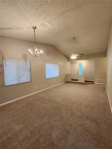 a view of a room with windows and chandelier