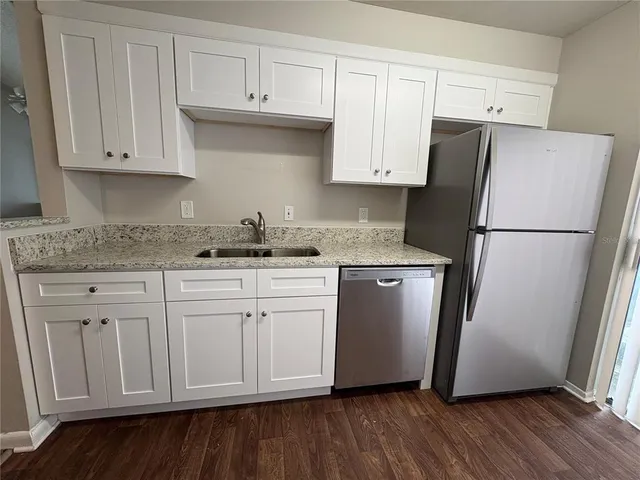 a white refrigerator freezer sitting inside of a kitchen