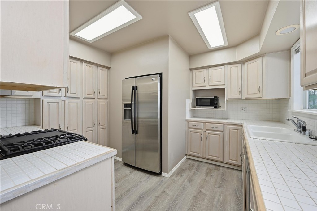 13674 Anderson Road Lower Lake, CA 95457 - Photo 11 of 38 a kitchen with white cabinets and stainless steel appliances