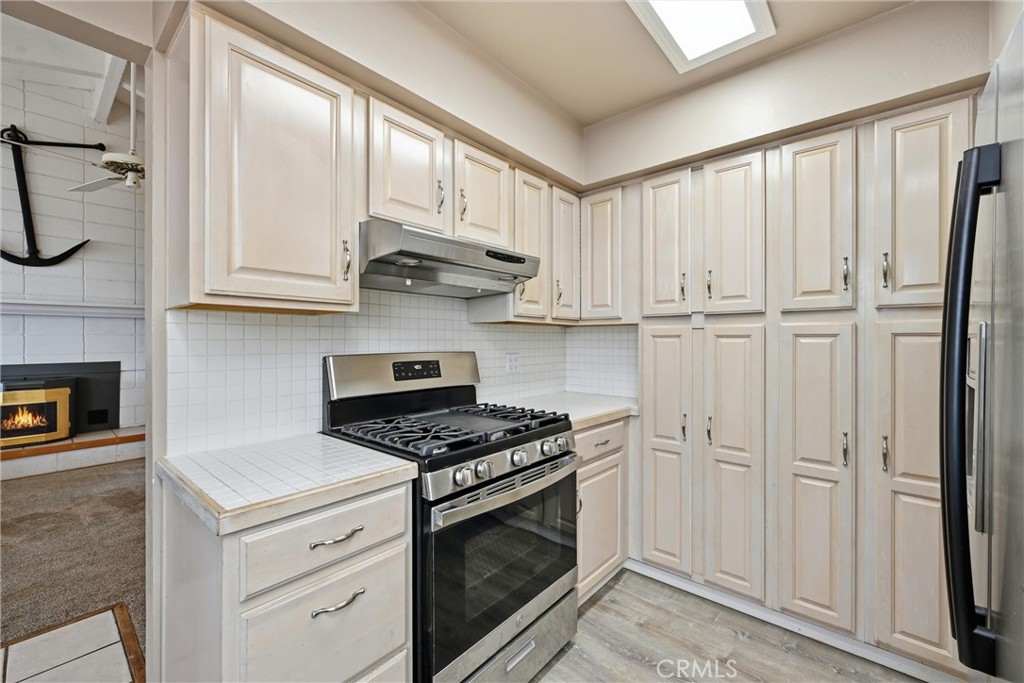 13674 Anderson Road Lower Lake, CA 95457 - Photo 13 of 38 a kitchen with white cabinets and a stove top oven