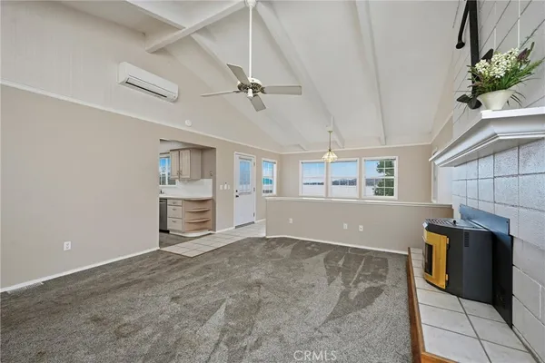 a view of a livingroom with furniture and a kitchen
