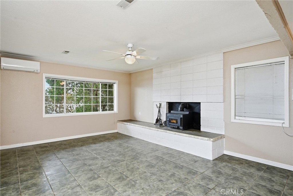 13674 Anderson Road Lower Lake, CA 95457 - Photo 23 of 38 a view of an empty room with a fireplace and a window
