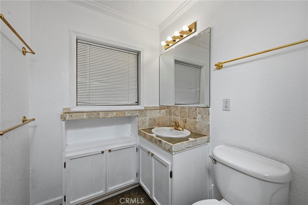13674 Anderson Road Lower Lake, CA 95457 - Photo 27 of 38 a bathroom with a toilet sink and mirror