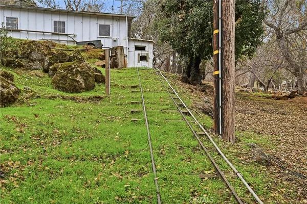a view of a backyard with table and chairs