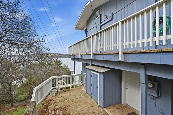 a view of balcony with wooden floor and fence