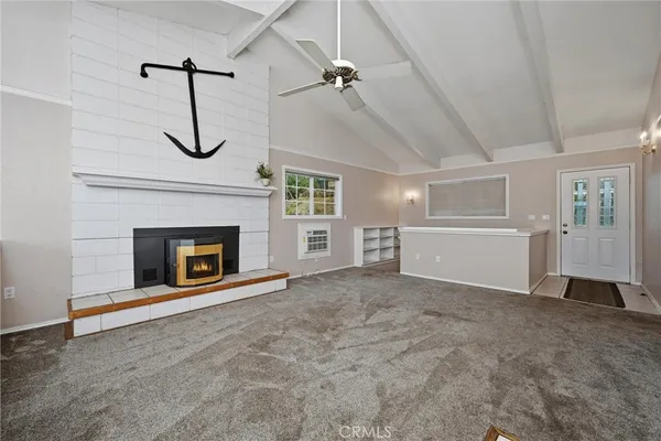 a view of a livingroom with a fireplace and a ceiling fan