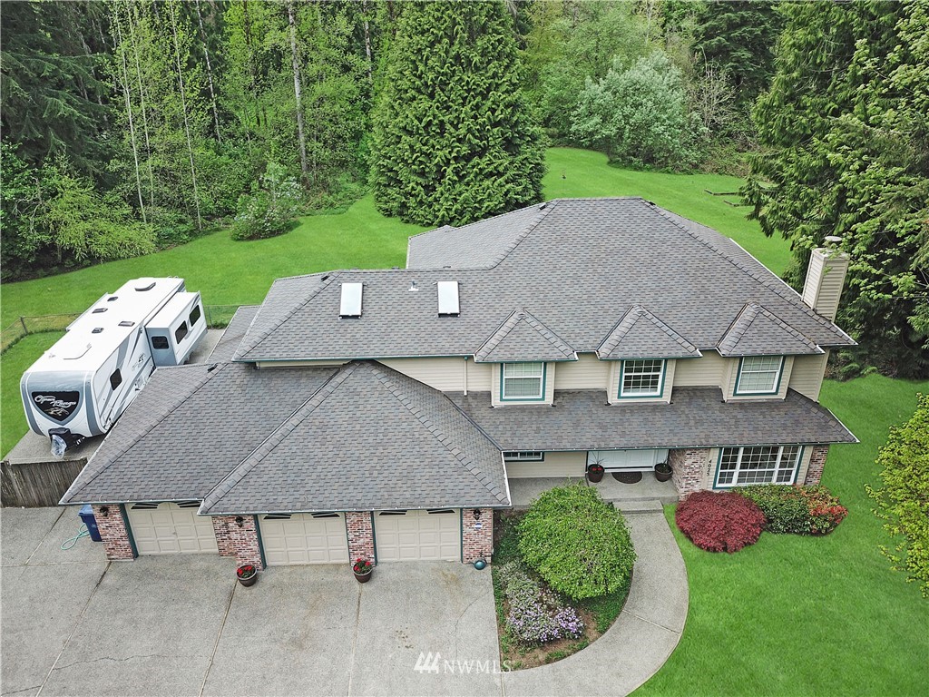 4025 204th Street Southeast Bothell, WA 98012 - Photo 2 of 35 an aerial view of a house with swimming pool and big yard