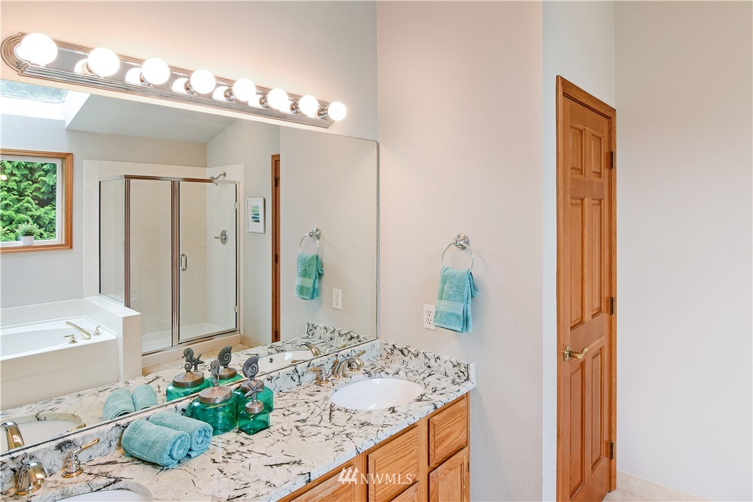 4025 204th Street Southeast Bothell, WA 98012 - Photo 25 of 35 a bathroom with a granite countertop sink and a mirror