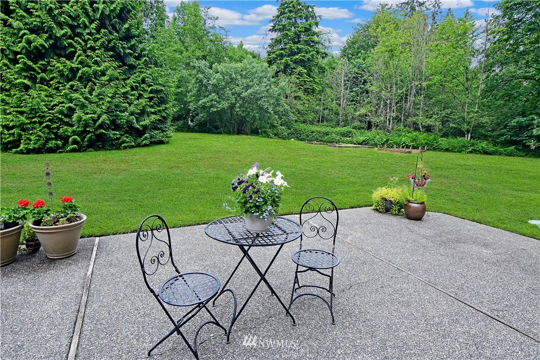 4025 204th Street Southeast Bothell, WA 98012 - Photo 29 of 35 a view of a chair and table on the garden