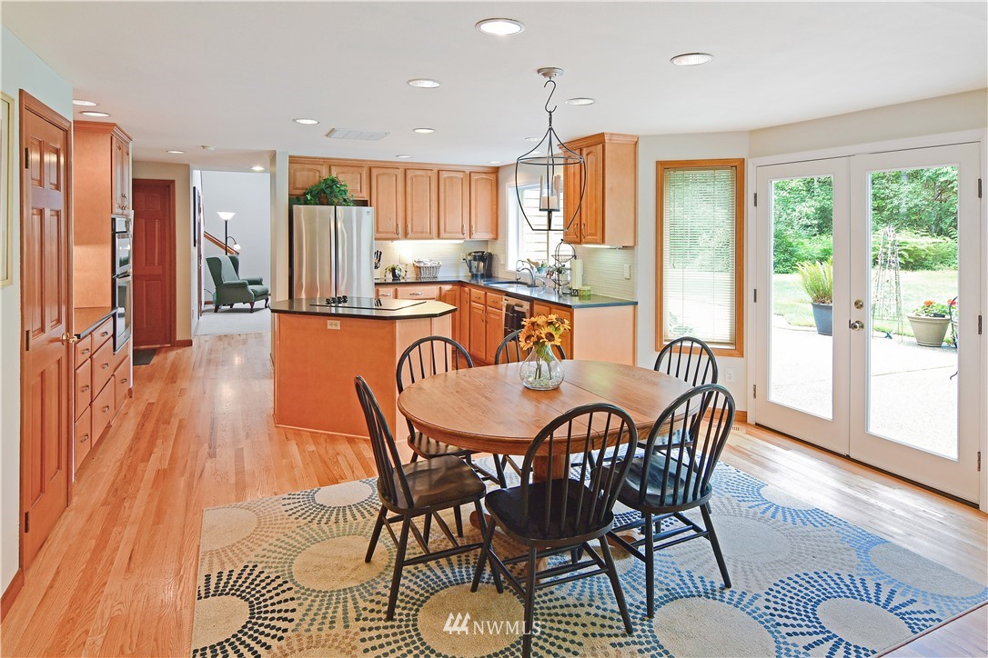 4025 204th Street Southeast Bothell, WA 98012 - Photo 8 of 35 a dining room with furniture a window and wooden floor