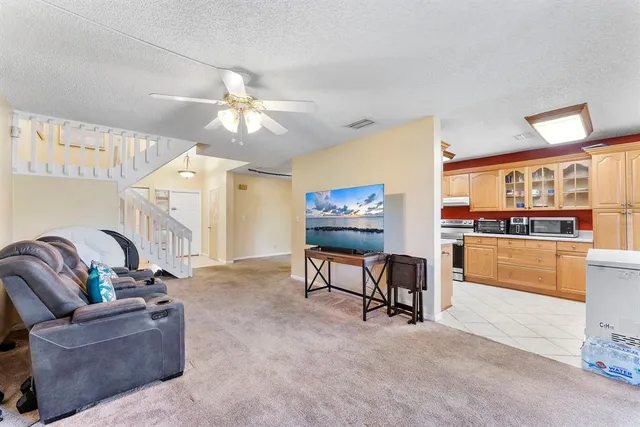 a living room with furniture and a kitchen view
